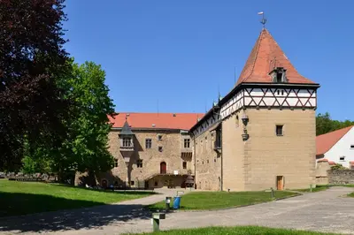 a large building with a tower on the side of it at Budyne Apartment II. in Budyně nad Ohří