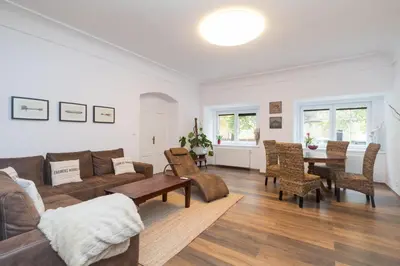 a living room with a couch and a table and chairs at Budyne Apartment II. in Budyně nad Ohří