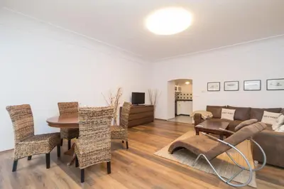a dining room and living room with a table and chairs at Budyne Apartment II. in Budyně nad Ohří
