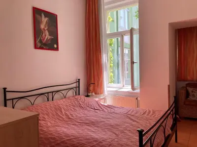 a bedroom with a bed and a window at Aparthotel City 5 in Prague