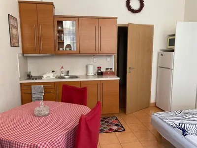 a kitchen with a table and a sink and a refrigerator at Aparthotel City 5 in Prague