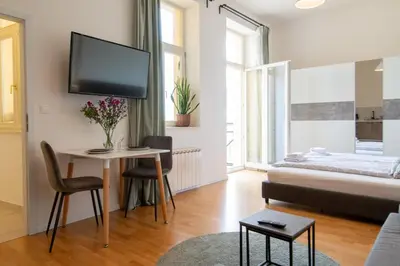 a room with a large window with towels on a bed at Stay Inn Apartments Stepanska in Prague