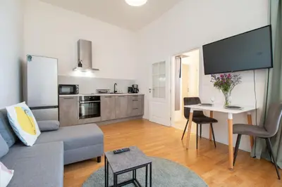 a kitchen with stainless steel appliances and a refrigerator at Stay Inn Apartments Stepanska in Prague