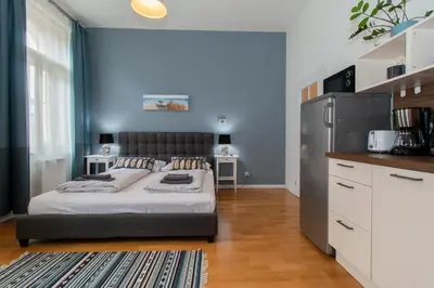 a small kitchen with a small table and chairs at Stay Inn Apartments Stepanska in Prague