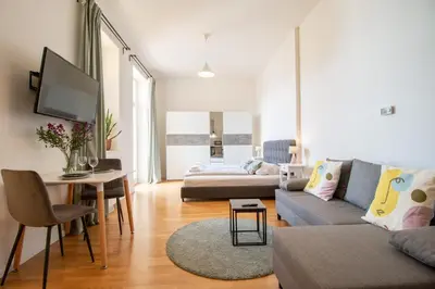 a living room with a couch and a table at Stay Inn Apartments Stepanska in Prague
