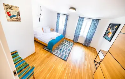 a small room with a bed and a couch at 5BR+3.5BT Wilson Central apt. in Prague