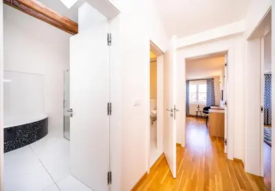 a bathroom with white walls and a glass shower stall at 5BR+3.5BT Wilson Central apt. in Prague