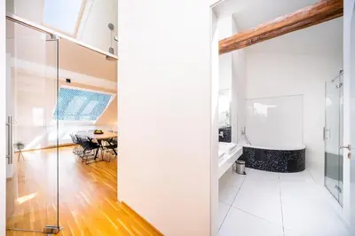 a bathroom with a glass shower and a table at 5BR+3.5BT Wilson Central apt. in Prague