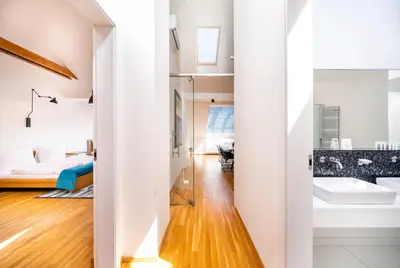 a bathroom with two sinks and a bedroom at 5BR+3.5BT Wilson Central apt. in Prague