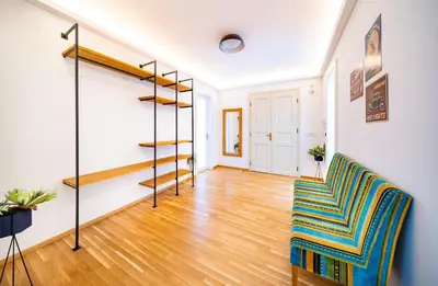 a living room with a staircase and a chair at 5BR+3.5BT Wilson Central apt. in Prague
