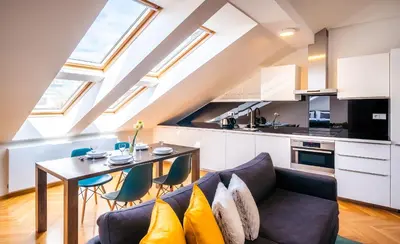 a living room with a couch and a table at Luxurious Woodrow Wilson apt in Prague centre in Prague