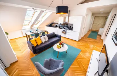 a living room with a couch and a table at Luxurious Woodrow Wilson apt in Prague centre in Prague