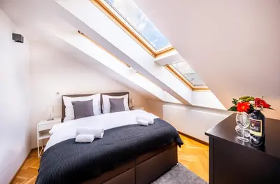 a bedroom with a bed in a attic at Luxurious Woodrow Wilson apt in Prague centre in Prague