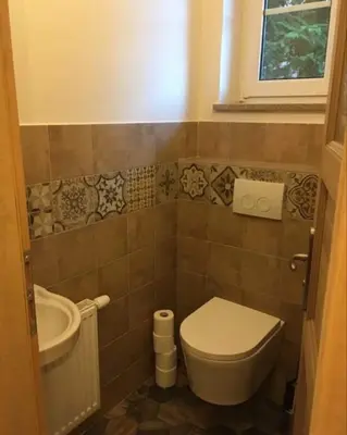 a bathroom with a toilet and a sink and a tub at Penzion Venkoff in Sázava