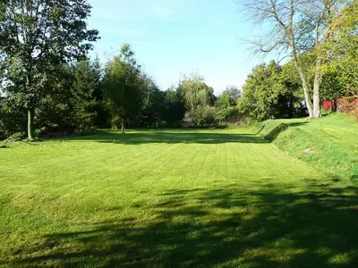 a large field of grass with trees in the background at Penzion Venkoff in Sázava
