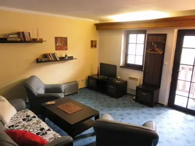 a living room with a couch and a table at U Královny Dagmar in Karlštejn