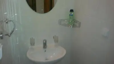 a white sink in a bathroom with a mirror at U Královny Dagmar in Karlštejn