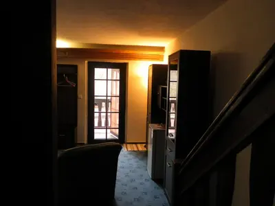 a hallway with a staircase and a door with a window at U Královny Dagmar in Karlštejn