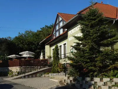a building with a tree in front of it at Penzion U Kašných in Mníšek pod Brdy