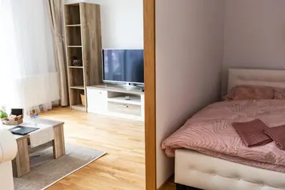 a mirror reflection of a bedroom with a bed and a television at Rezidence Hadovitá in Prague