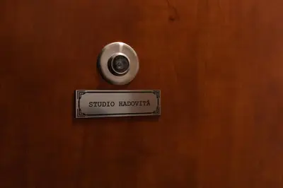 a sign on a wooden door with a handle at Rezidence Hadovitá in Prague