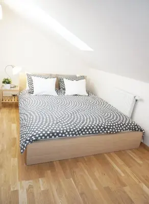 a bed with two pillows on it in a room at Naru house 9 in Prague