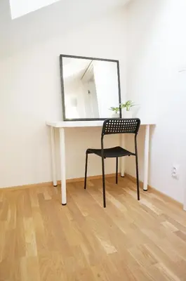 a mirror sitting on top of a desk with a chair at Naru house 9 in Prague