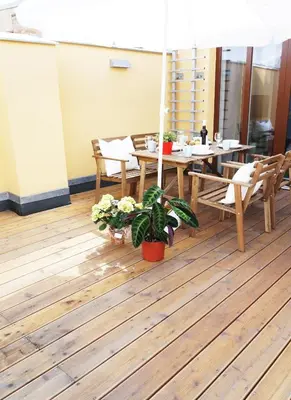a dining room with a table and chairs on a wooden floor at Naru house 9 in Prague
