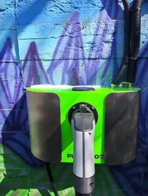 a green and gray machine sitting in front of a wall at Camping Matyáš in Vrané nad Vltavou
