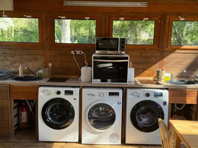 a kitchen with two washing machines and a microwave at Camping Matyáš in Vrané nad Vltavou