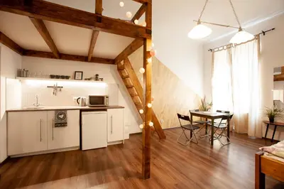 a kitchen and living room with a table and chairs at Wow Wow Apartment in Prague