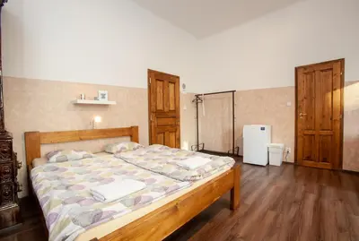 a bedroom with a bed in a room with wooden floors at Wow Wow Apartment in Prague