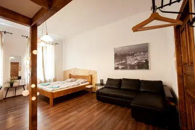 a living room with a couch and a bed at Wow Wow Apartment in Prague