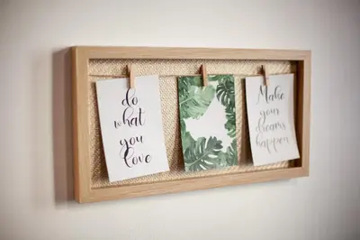 a wooden picture frame with four signs on a wall at Wow Wow Apartment in Prague