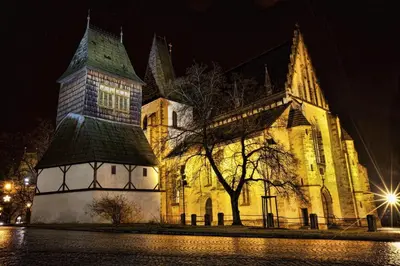 an old church at night with lights on it at Wellness Hotel Svoboda in Rakovník