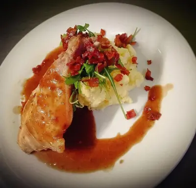 a plate of food with meat and mashed potatoes at Wellness Hotel Svoboda in Rakovník