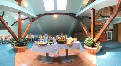a dining room with two tables with food on it at Wellness Hotel Svoboda in Rakovník