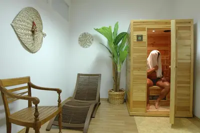 a person sitting on a chair in a room at Wellness Hotel Svoboda in Rakovník