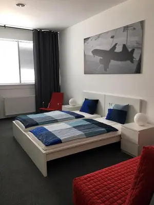 a bedroom with two beds and an airplane on the wall at AeroRooms in Prague