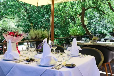 a table with white napkins and wine glasses on it at Areal Botanika in Unhošť