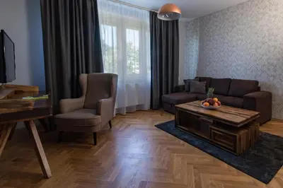 a living room with a couch and a table at Areal Botanika in Unhošť