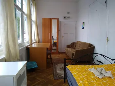 a bedroom with a bed and a chair and a desk at Rooms in Prague-BIG+Comfy in Prague
