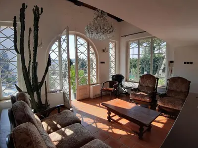 a living room with a couch and chairs and a cactus at Rooms in Prague-BIG+Comfy in Prague