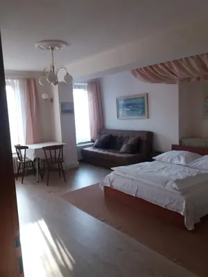 a bedroom with a bed and a couch and a table at Apartmány Sedmikráska in Tehovec