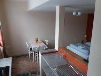 a small room with a table and a bed at Apartmány Sedmikráska in Tehovec