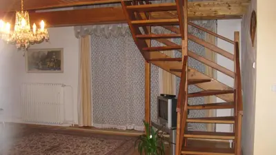 a staircase in a living room next to a window at Apartmány Sedmikráska in Tehovec