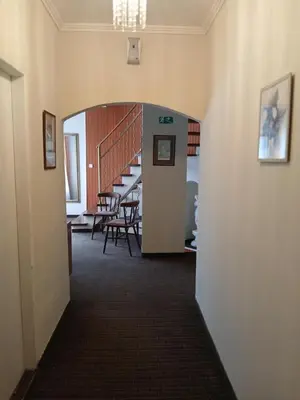 a hallway leading to a dining room with stairs at Apartmány Sedmikráska in Tehovec