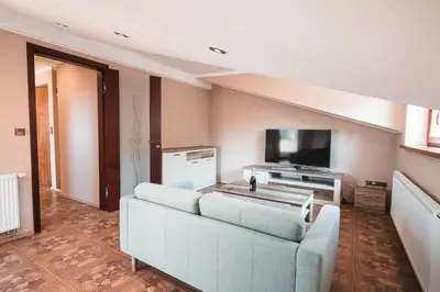 a living room with a couch and a flat screen tv at POINT flat, beautiful view from terrace to Prague Castle in Prague