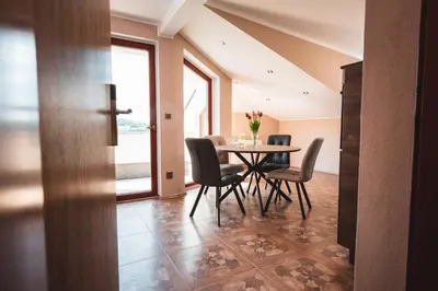 a dining room with a table and chairs at POINT flat, beautiful view from terrace to Prague Castle in Prague