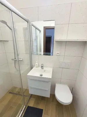 a bathroom with a sink and a toilet and a mirror at Minihotel Vitex in Prague